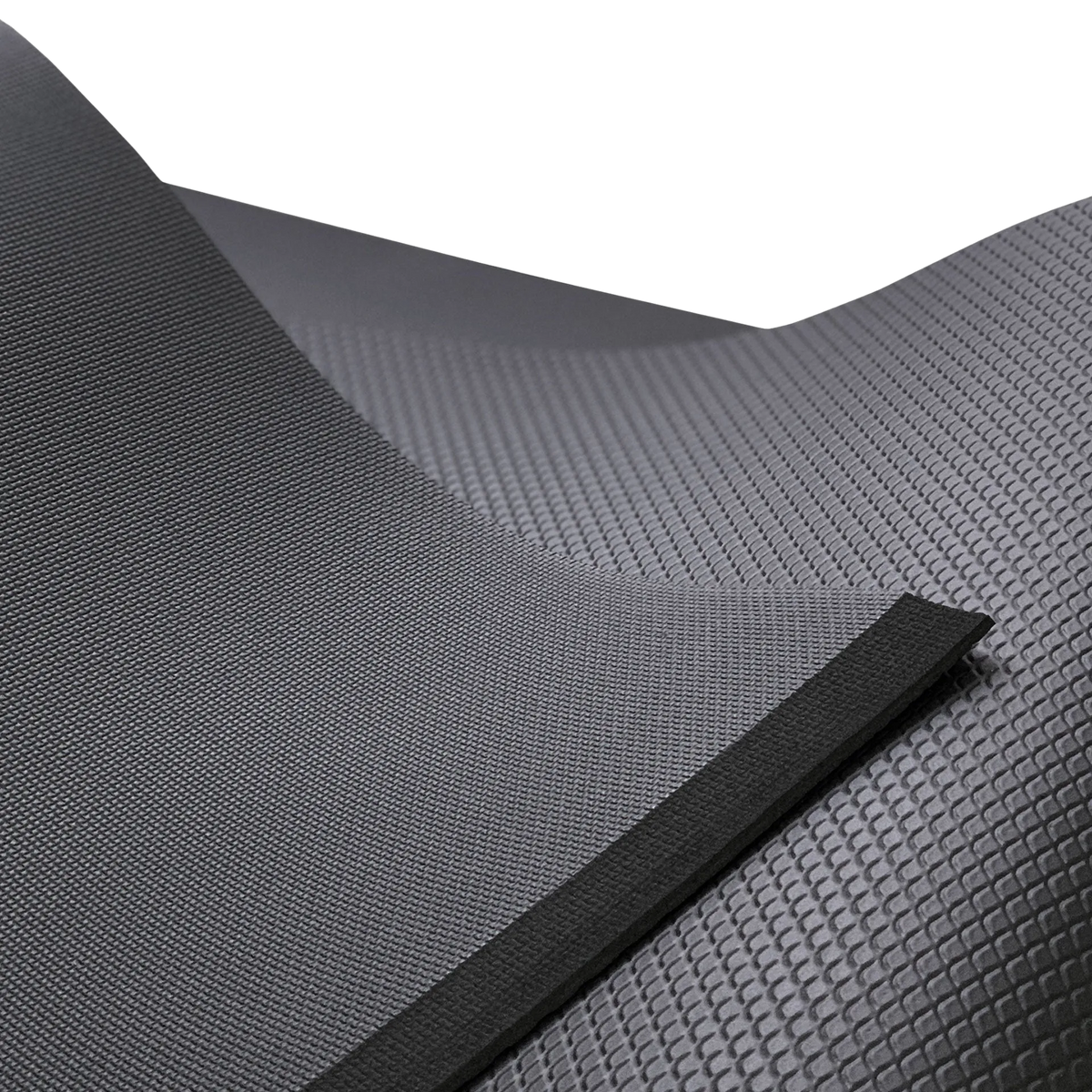 Detailaufnahme der Gymnastikmatte der Marke ARTZT thepro mit kontrastierender Oberflächenstruktur; die rutschfeste Unterseite und die fein strukturierte Oberseite sind im Querschnitt sichtbar und verdeutlichen Materialstärke sowie hochwertige Verarbeitung.